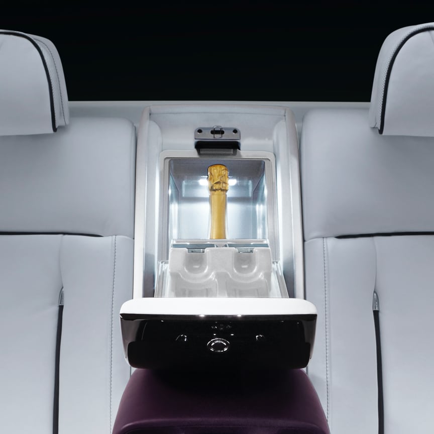 <p>One of the pinnacle Rolls-Royce Motor Cars accessories, the illuminated interior of the Coolbox, with integral mirror, accommodates two 0.75 litre champagne bottles and storage for two champagne flutes. The two stage cooling settings keep food and drink at the perfect temperature. For added convenience, a glass holder can be securely fixed to the cup-holders in the rear armrest.</p>