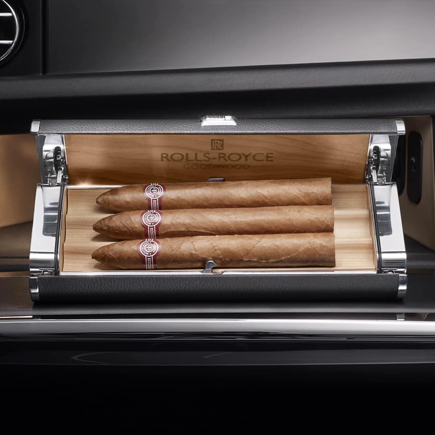 <p>This wood-lined Humidor is beautifully trimmed with polished aluminium, leather detailing, and is discreetly located within the glove box.</p>