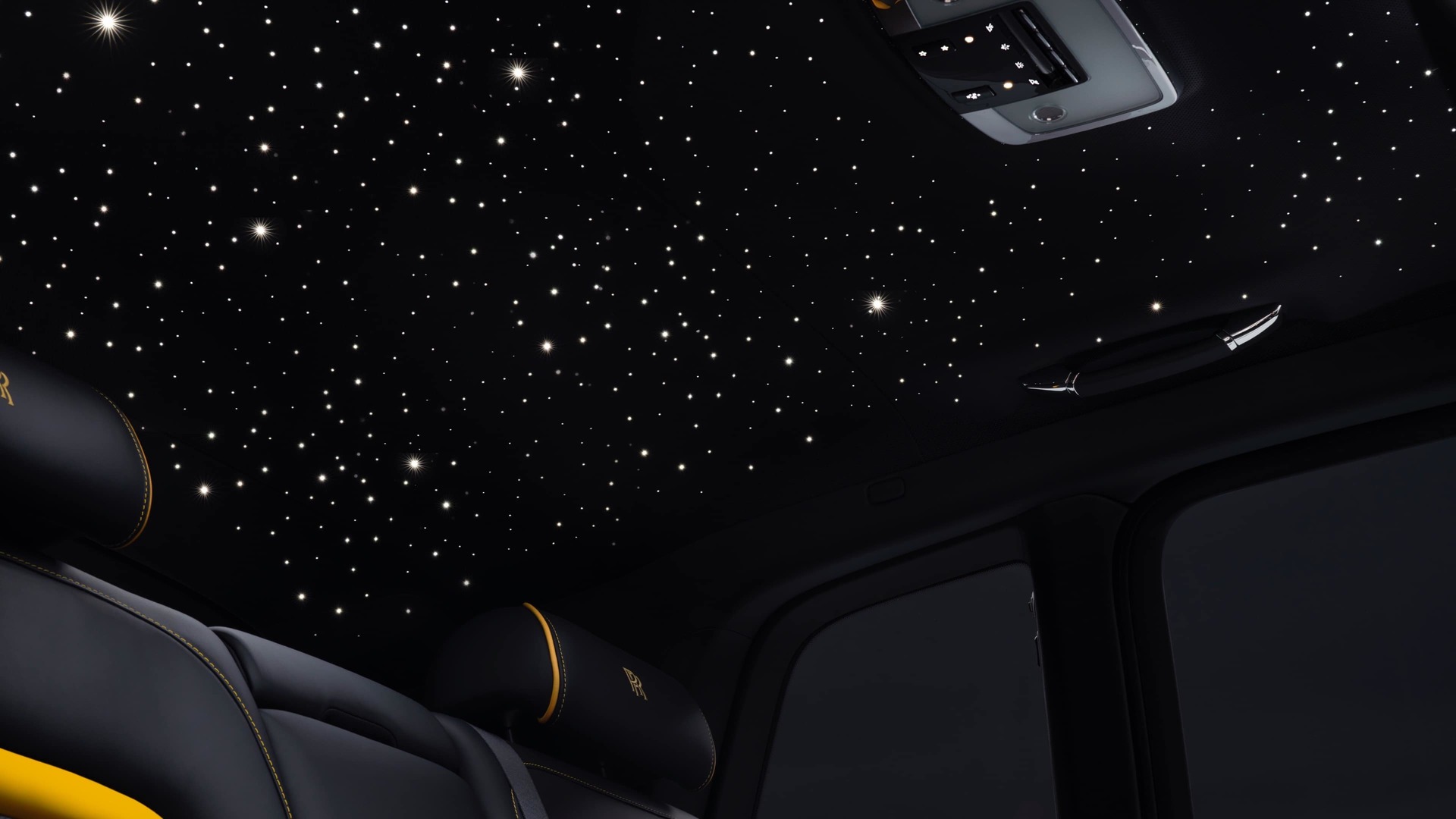 Shows the starlight headliner accessory fitted in a Rolls-Royce Cullinan, the dark shot highlighting the constellation of lights against the material of the headliner