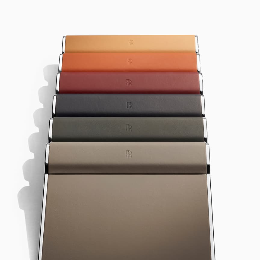 <p>Handcrafted in Rolls-Royce leather, these high-quality writing pads make working from your Phantom the ultimate effortless experience. Select from a range of colours to complement your interior leather scheme and, when they’re not in use, neatly stow them in the rear seat pocket.</p>