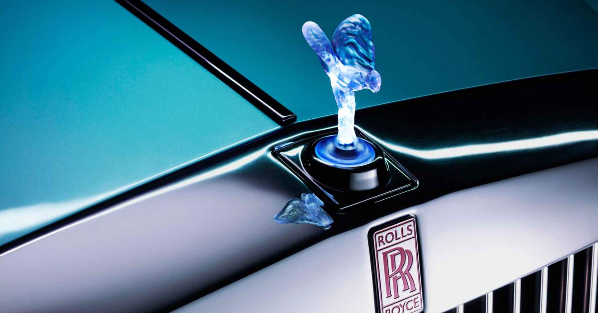 Close-up of a bespoke Spirit of Ecstasy and Rolls-Royce motor cars logo on a prototype electric vehicle.