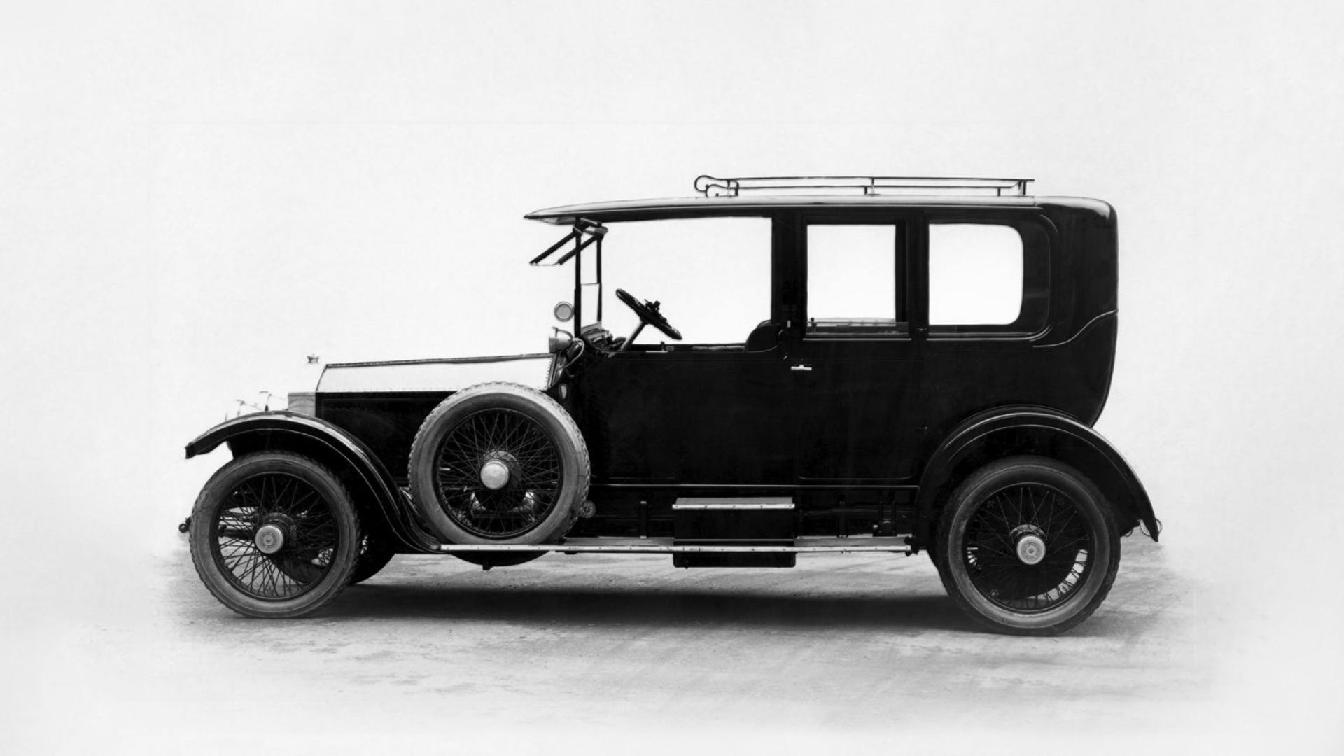 Side profile exterior of an traditional, original Rolls-Royce motor car.