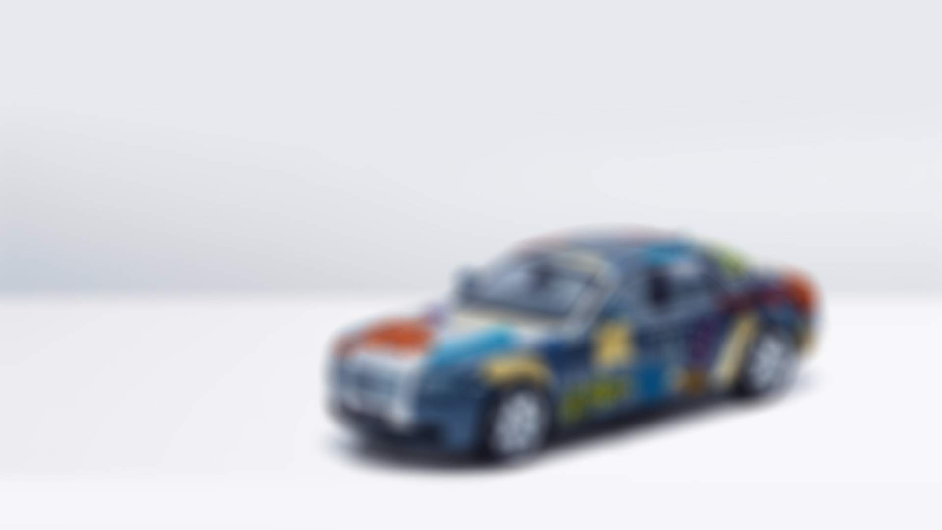 A miniature Rolls-Royce Ghost with a patchwork patter paint job. A piece made in collaboration between Rolls-Royce, Breast Cancer Care UK and some of the biggest names in contemporary art