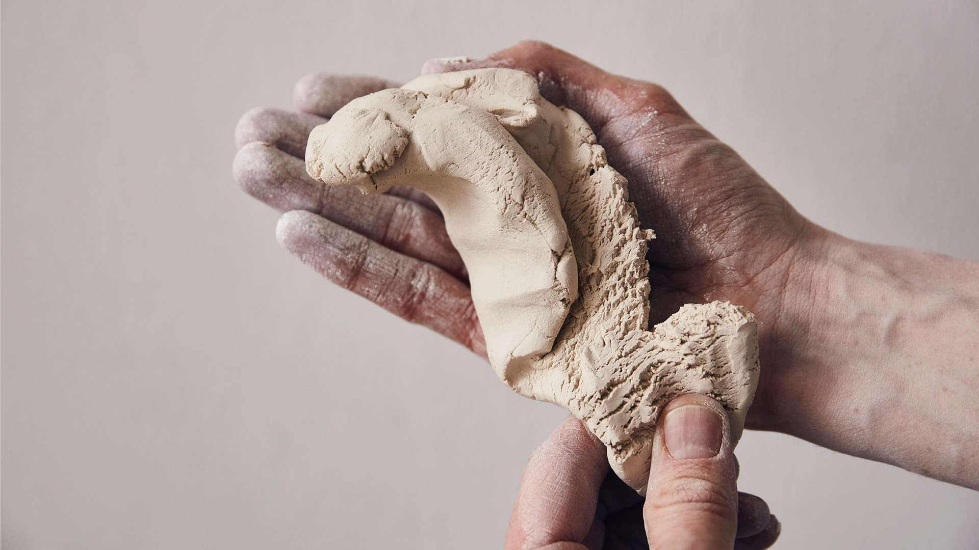 A craftsman moulds the materials used in the process of creating a Bespoke Phantom Gallery featuring porcelain roses