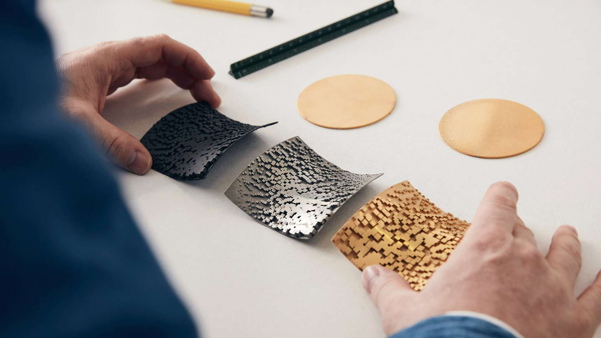 A designer works on Digital Soul, a Bespoke Phantom Gallery. The image shows the various steps taken to recreate a customer's DNA onto 24k plated gold.