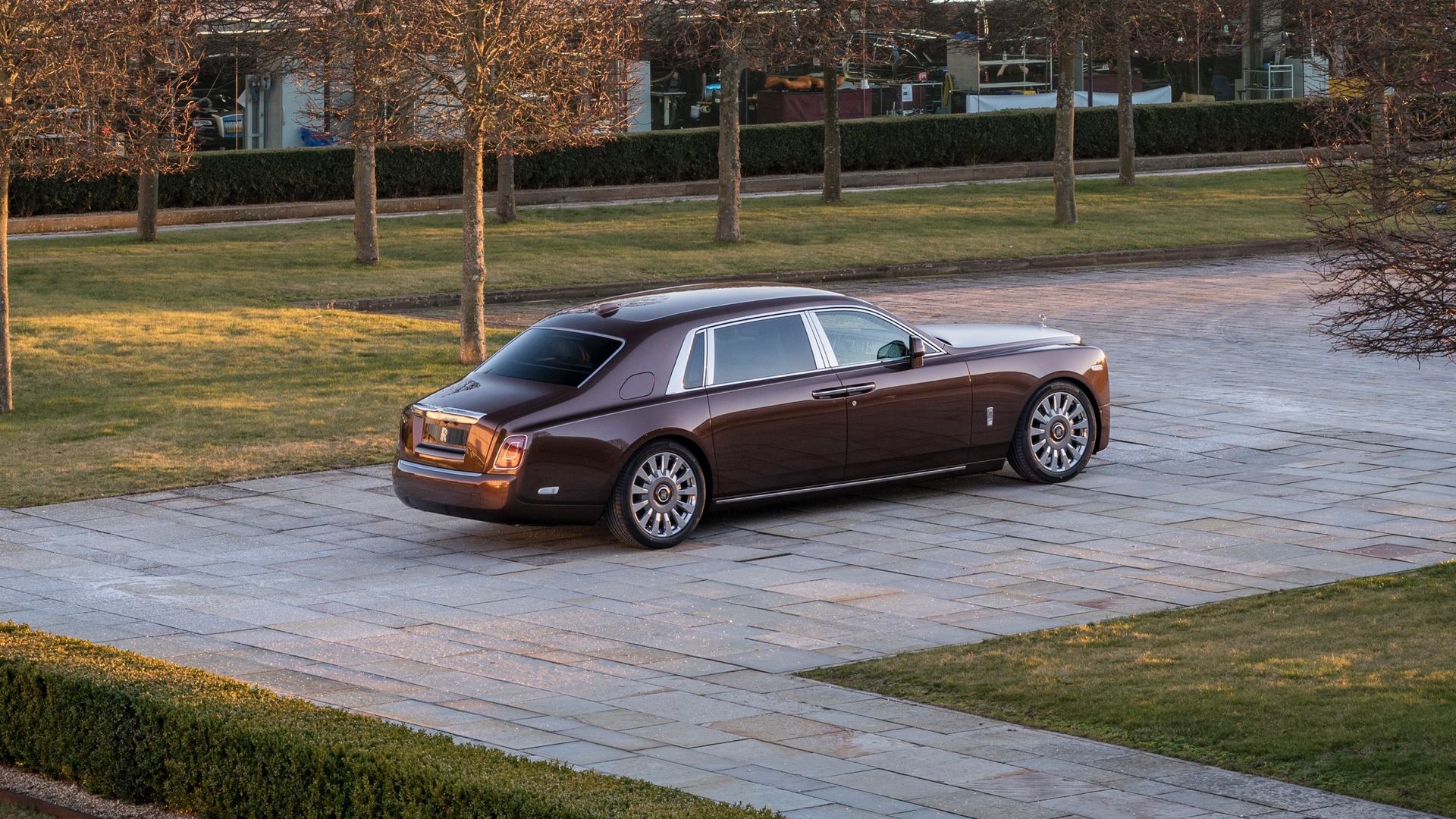 An exterior far away shot of a copper Rolls-Royce Phantom EWB model