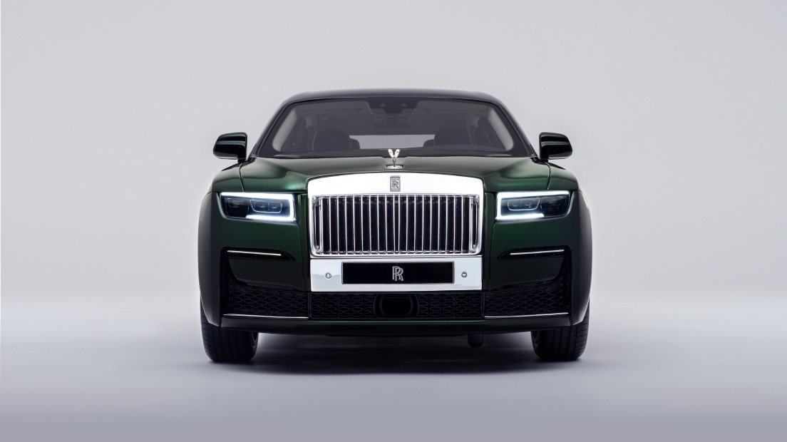 Front on Green Ghost Extended with head lamps on in a studio backdrop