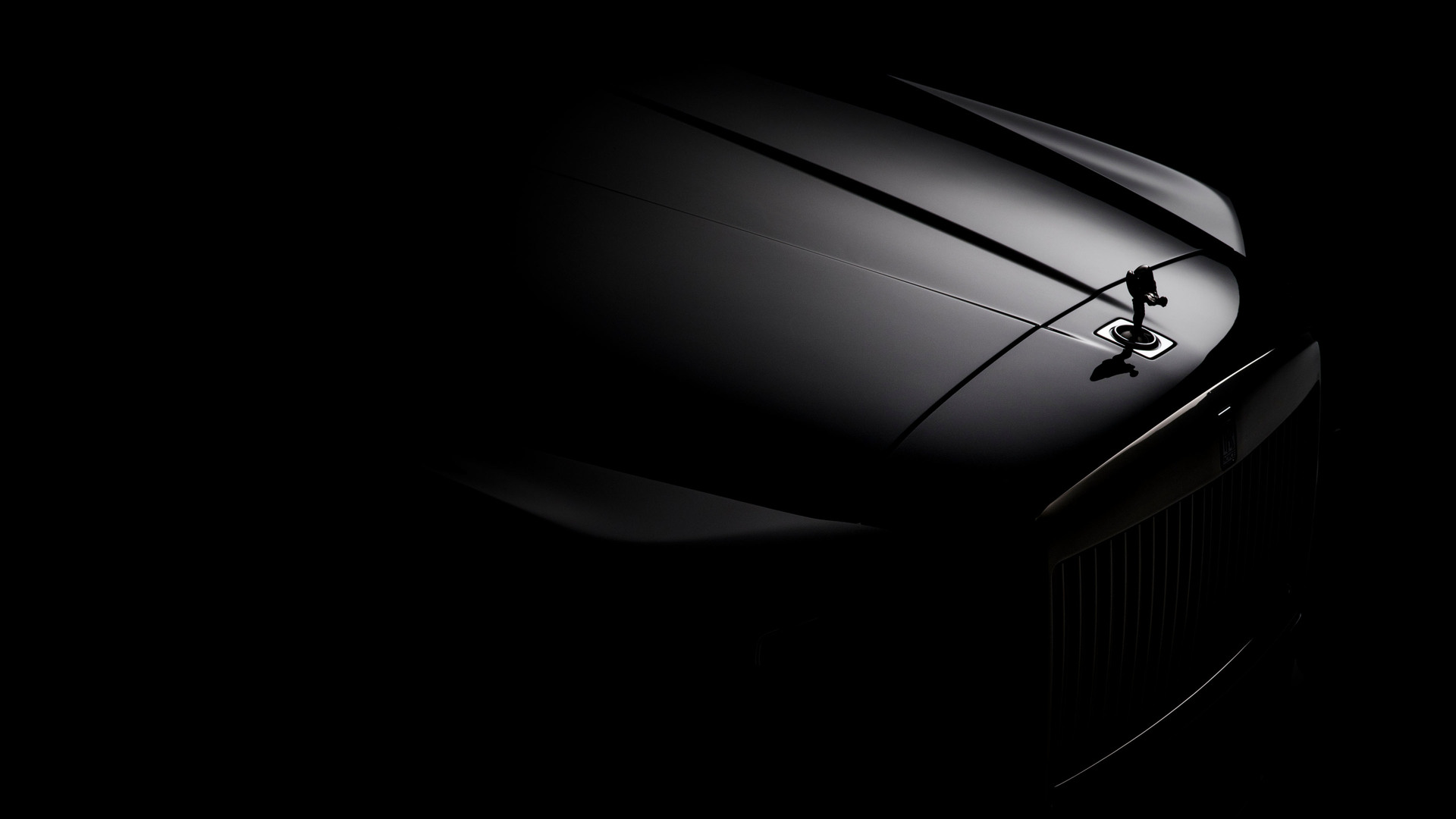 Exterior of a dimly lit spirit of ecstasy on the front of a Rolls-Royce Motor Cars.