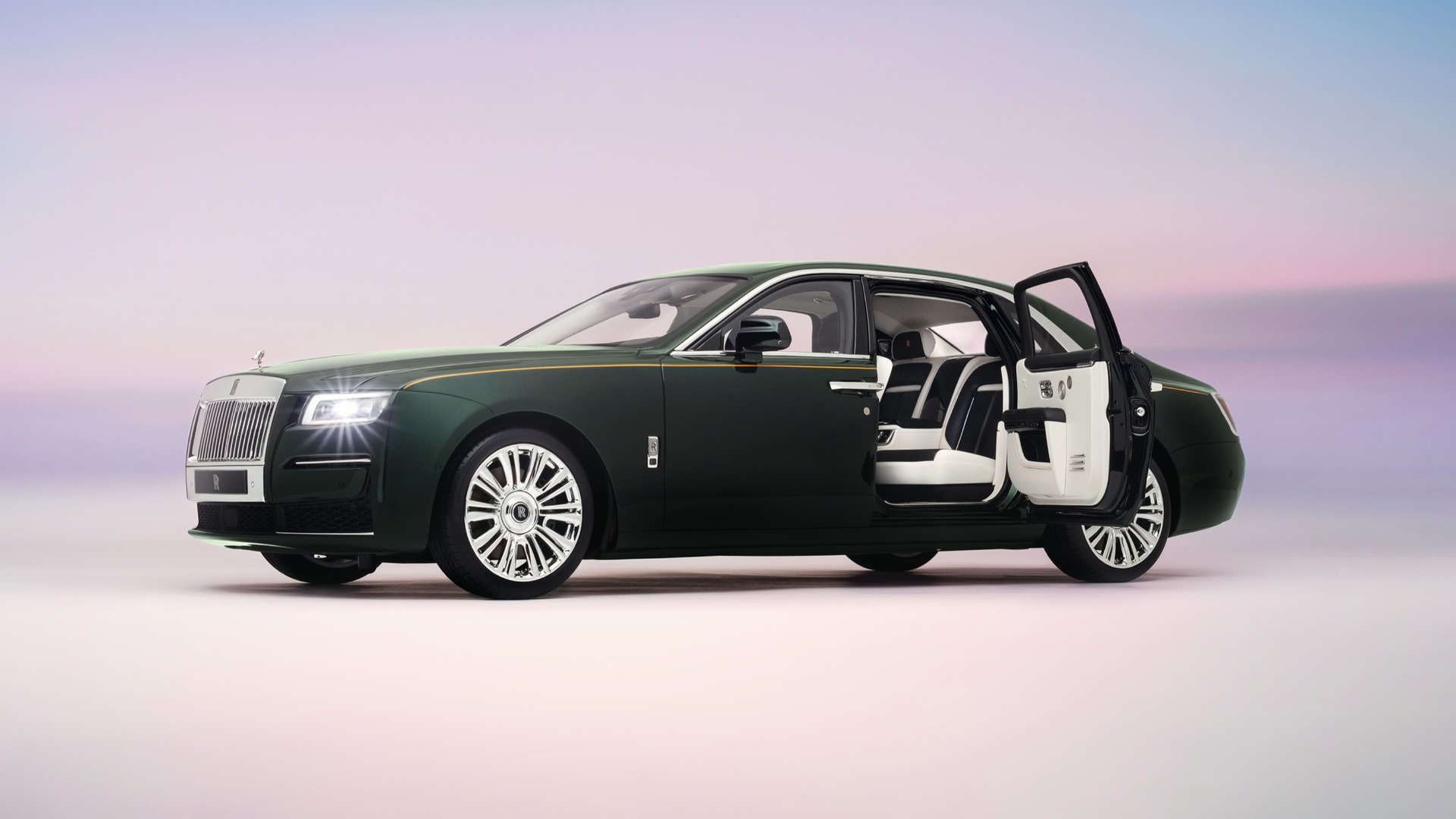 A side profile shot of the Rolls-Royce Ghost replica in dark green, with the rear door opened showing the interior