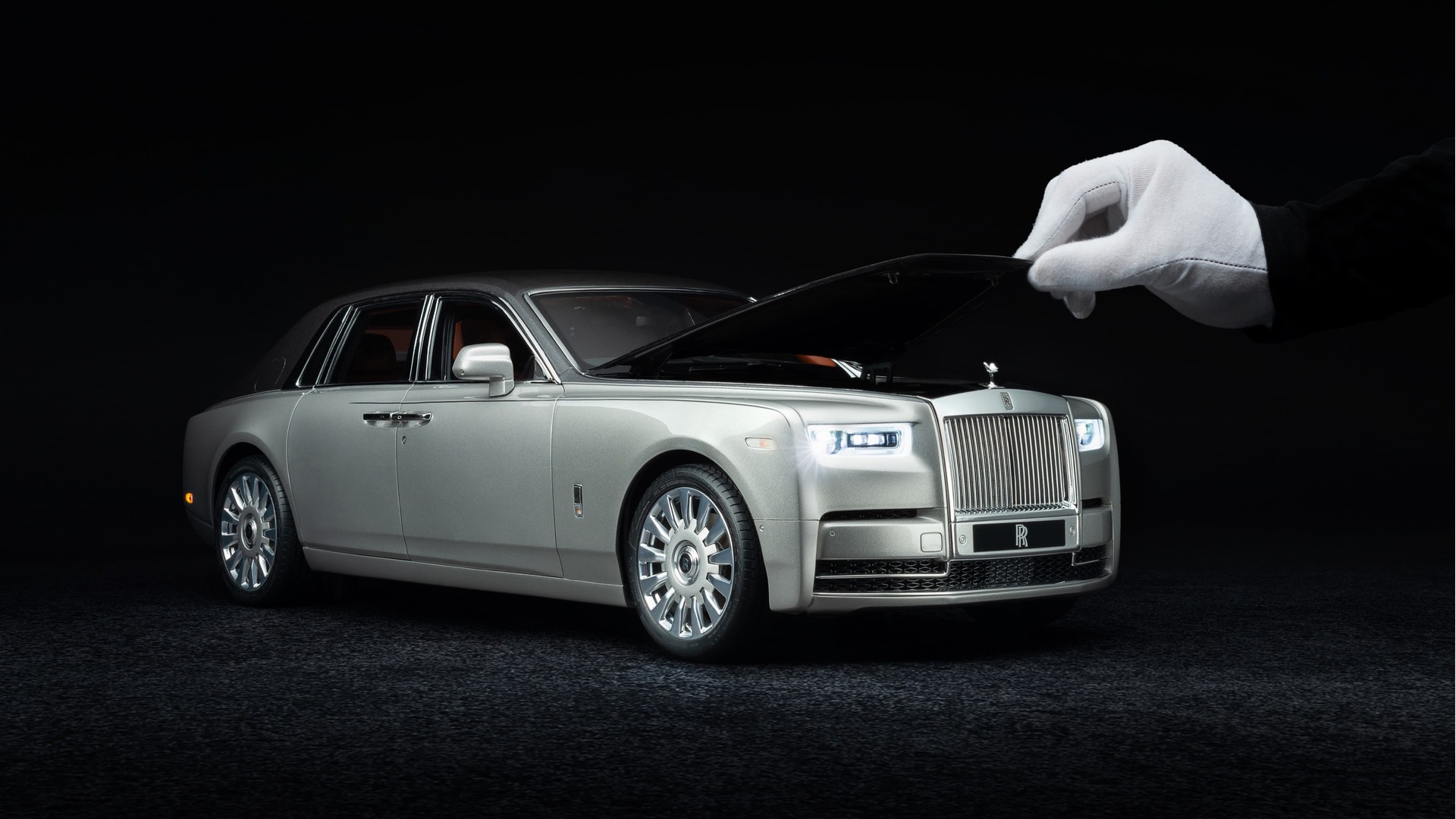 3/4 front exterior view of 1:8 scale model of the Rolls-Royce Phantom motor car with hand holding bonnet open