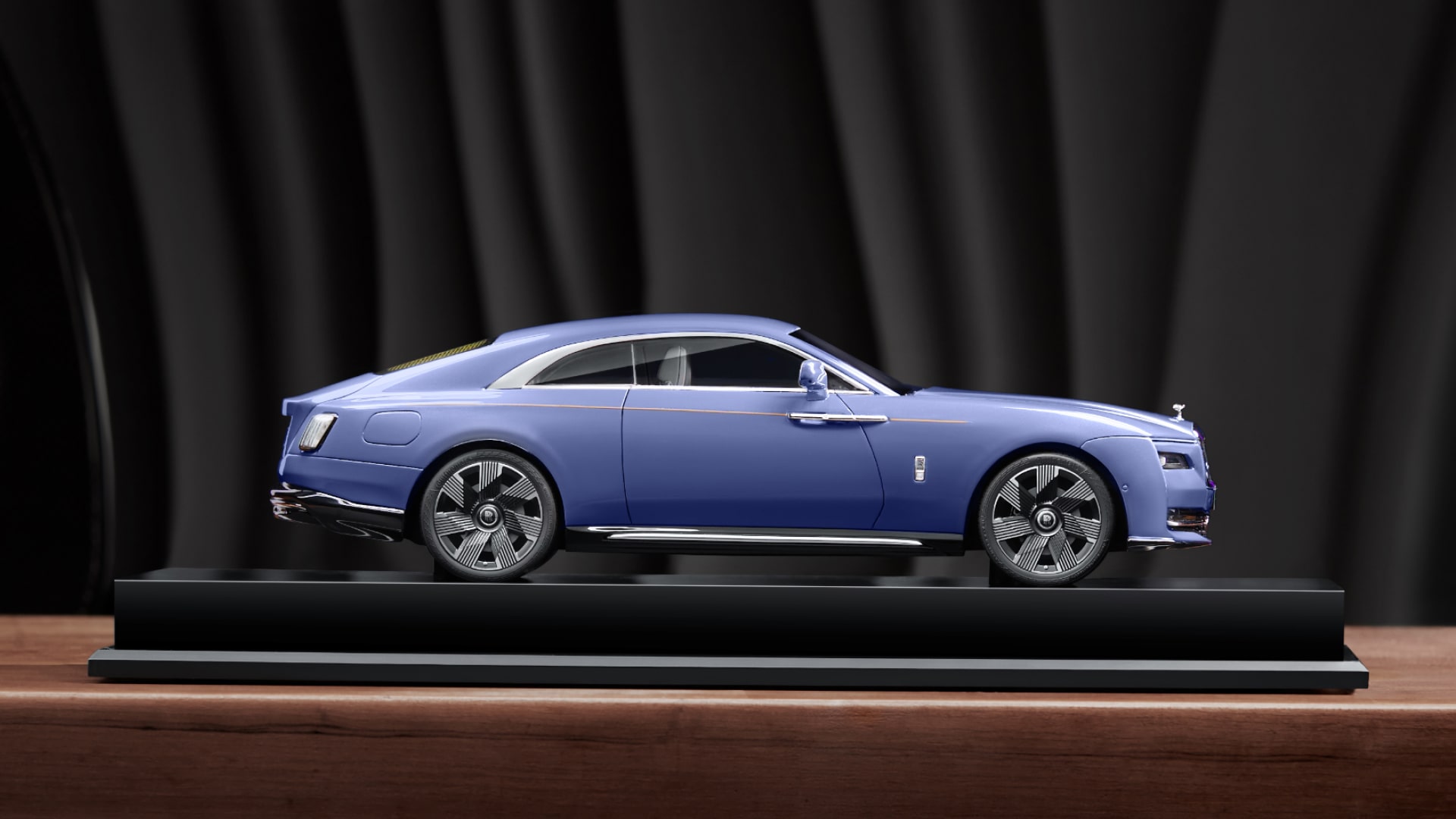 Side view of a a replica of the Rolls Royce Spectre model in blue colour