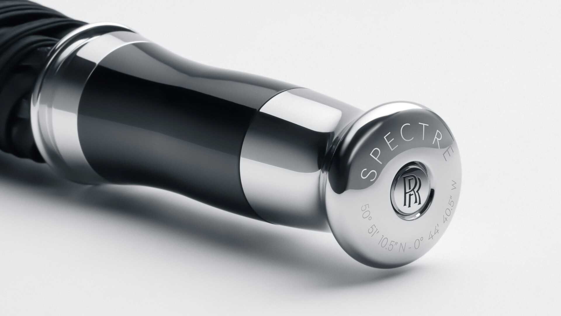 Detailed view of the etching on the handle of the Rolls-Royce umbrella - Spectre edition