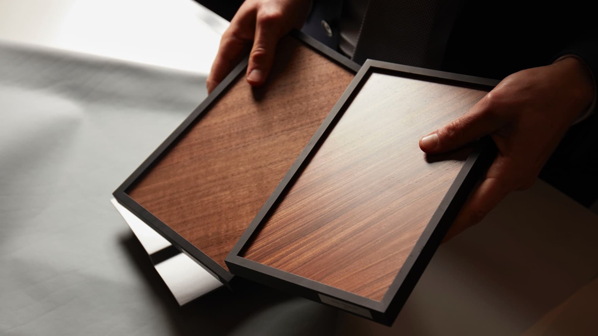 Consultant at Rolls-Royce certified dealer handles veneer sample 