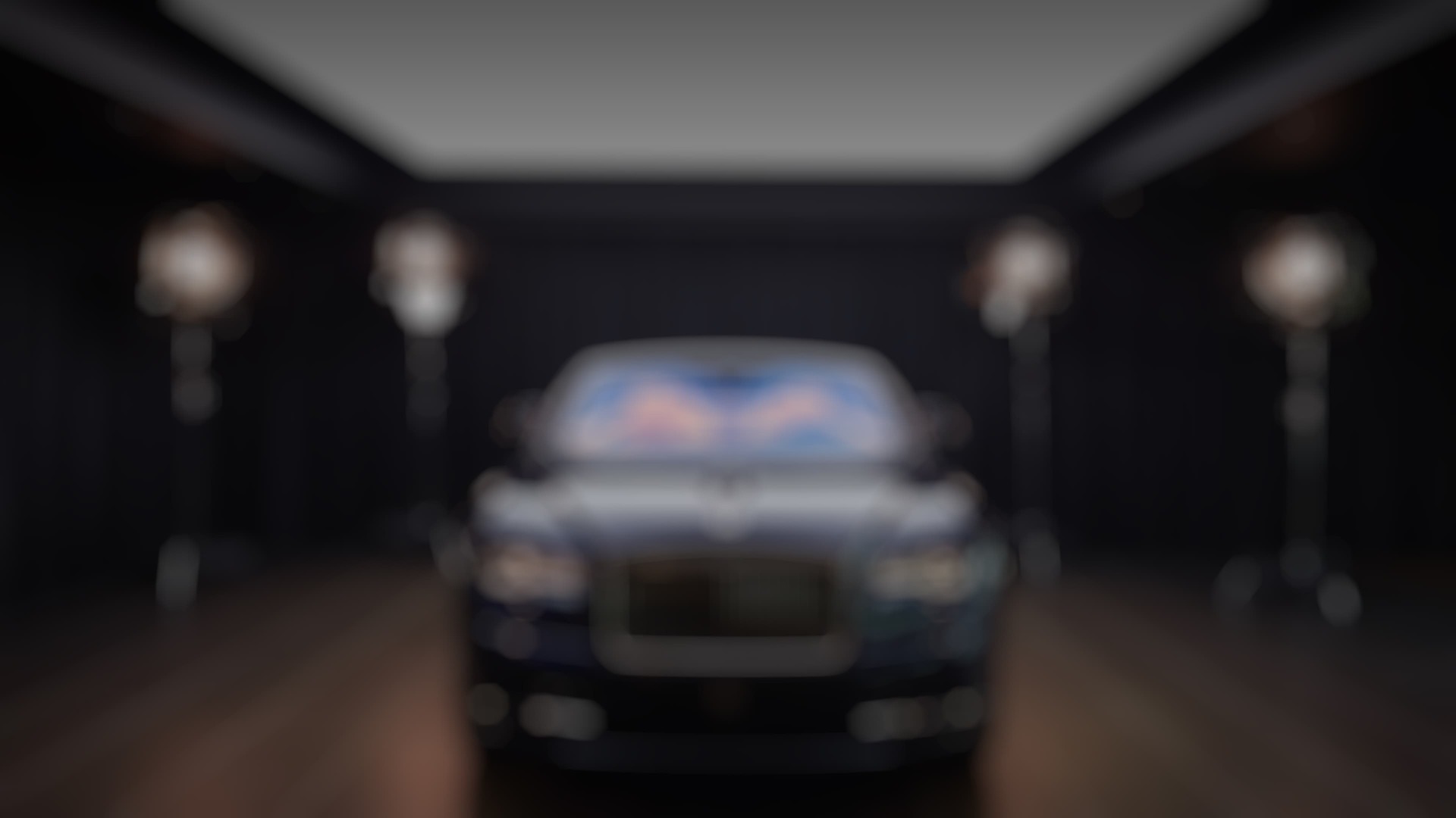 Front exterior of stationary Rolls-Royce motor car in showroom space