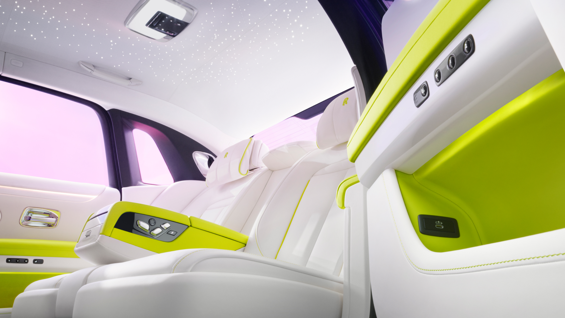 An interior back seat view from a Rolls-Royce Ghost, with the focus on the arm rest and starlight headliner