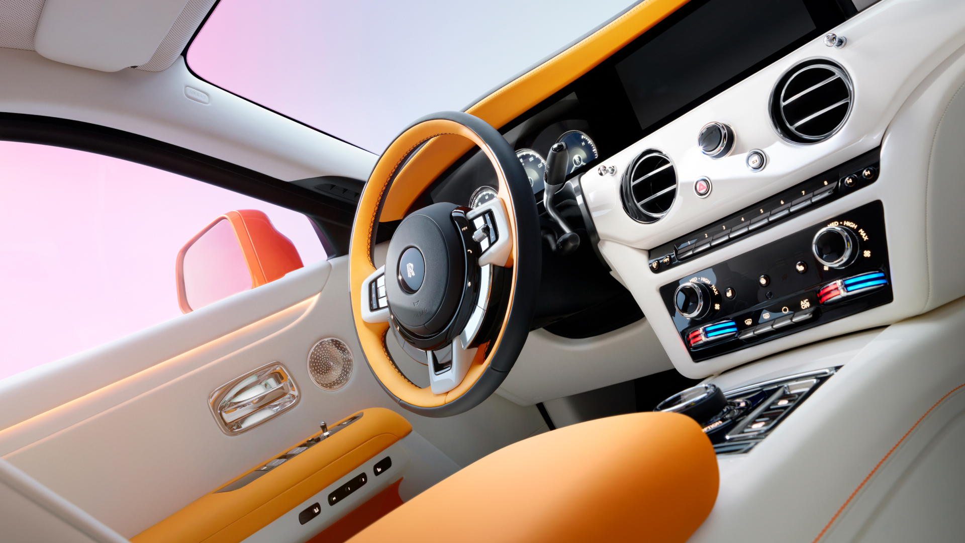 The front cabin of Ghost, featuring a Two-Tone Black and Mandarin Orange steering wheel.  
