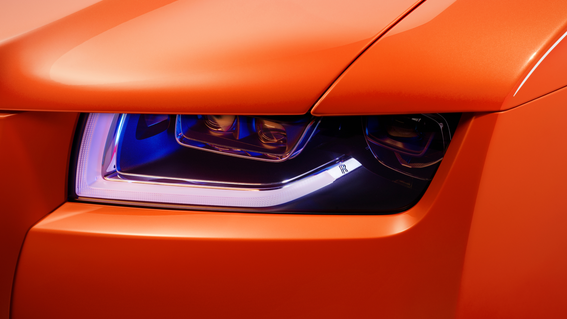 Close view of the front light of Rolls-Royce Ghost in orange with the light on