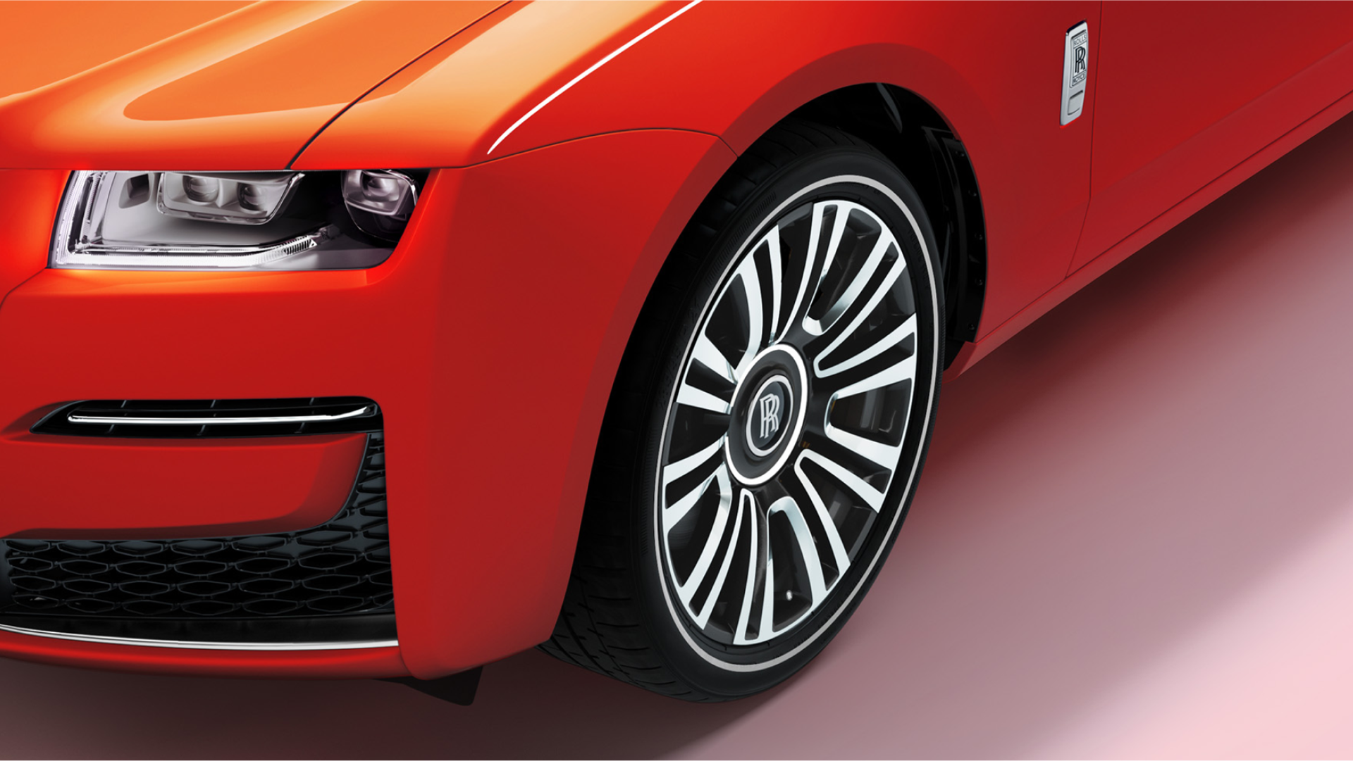 Close up of the front wheel and headlight of the Orange Metallic Ghost