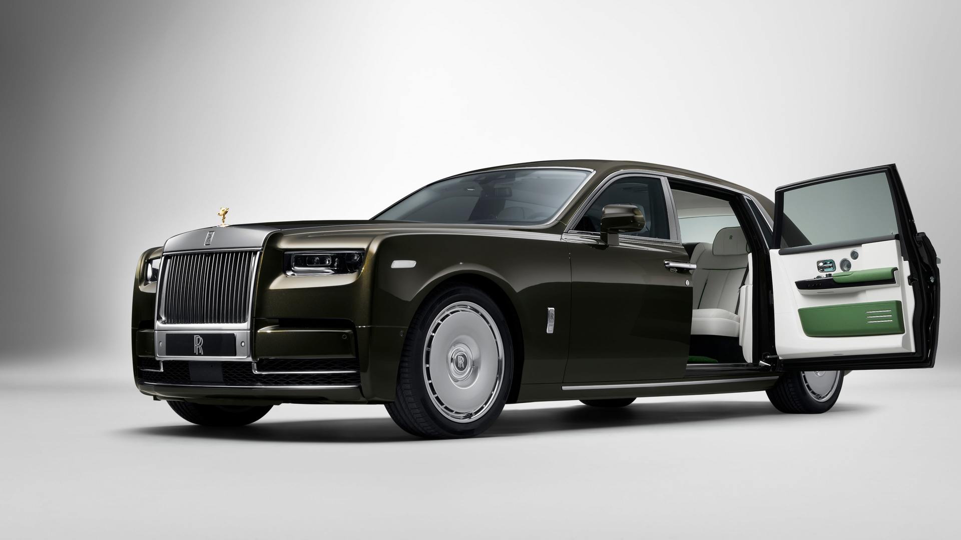 A Rolls-Royce Phantom Extended in dark green with the door open and white background