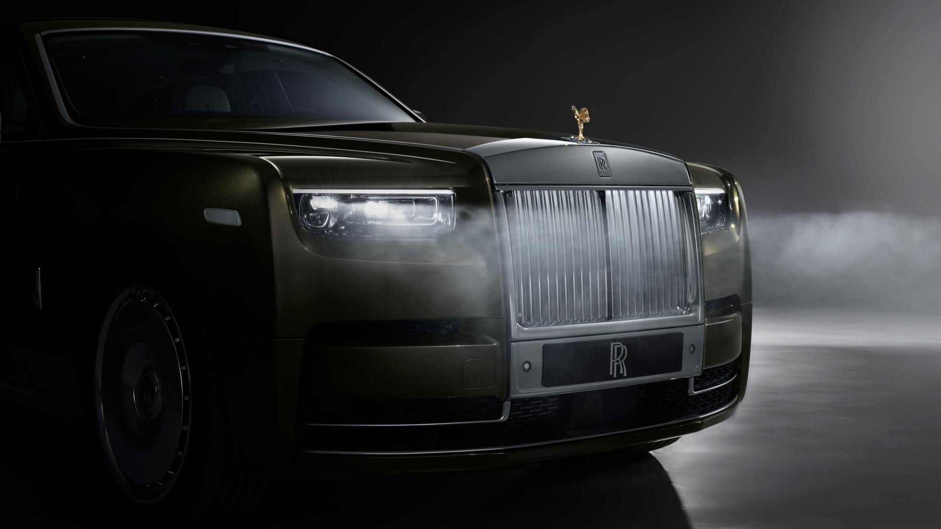 The grille of a Rolls-Royce Phantom Extended with the lights on in the dark