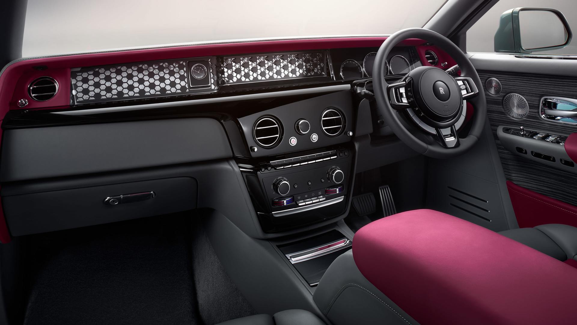An interior shot of the dashboard, fascia, steering wheel and arm rest of a Rolls-Royce Phantom Series II