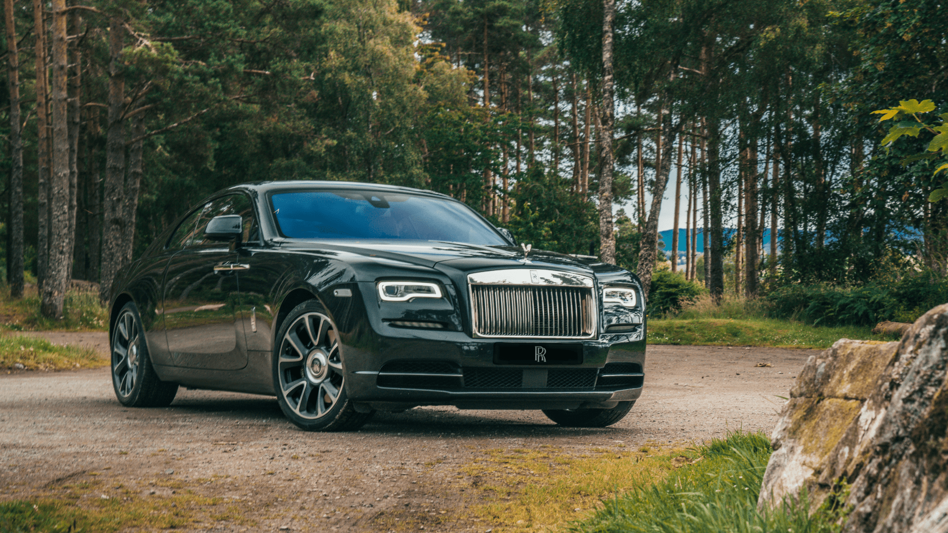 Side profile shot of a Rolls-Royce Wraith in the woods