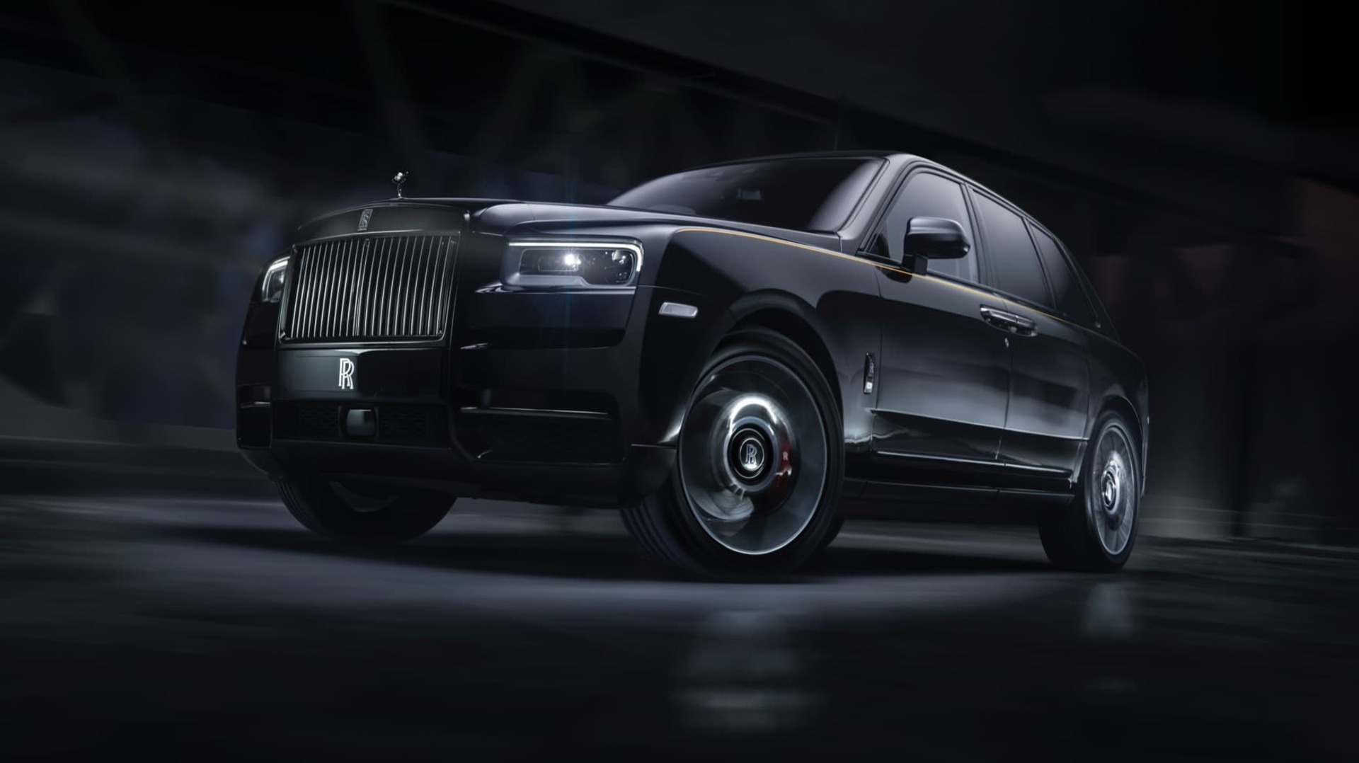 Dynamic 3/4 front exterior shot of Rolls-Royce Black Badge Cullinan motor car driving on road