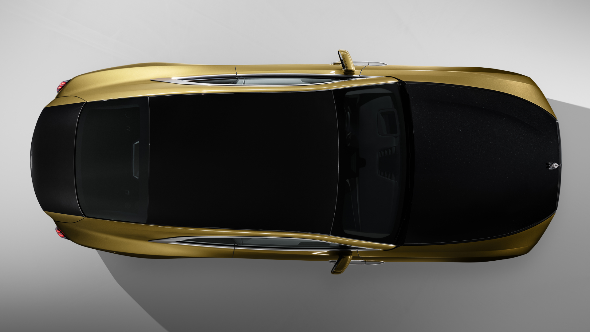Bird eye view shot of Spectre displaying sleek gold sides with crisp black exterior on the top of the car